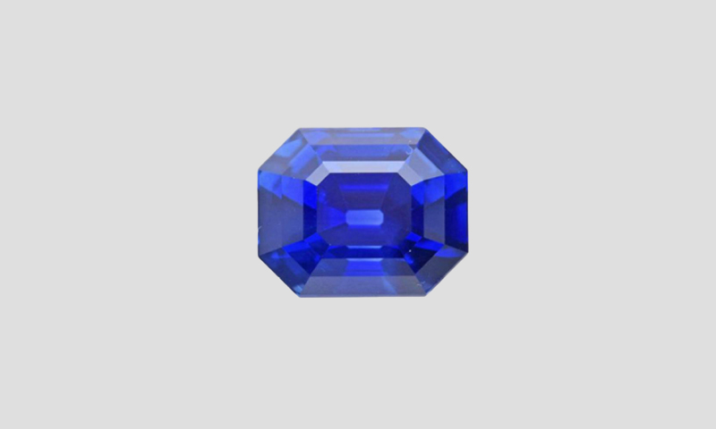 blue cushion cut sapphire on a dark background